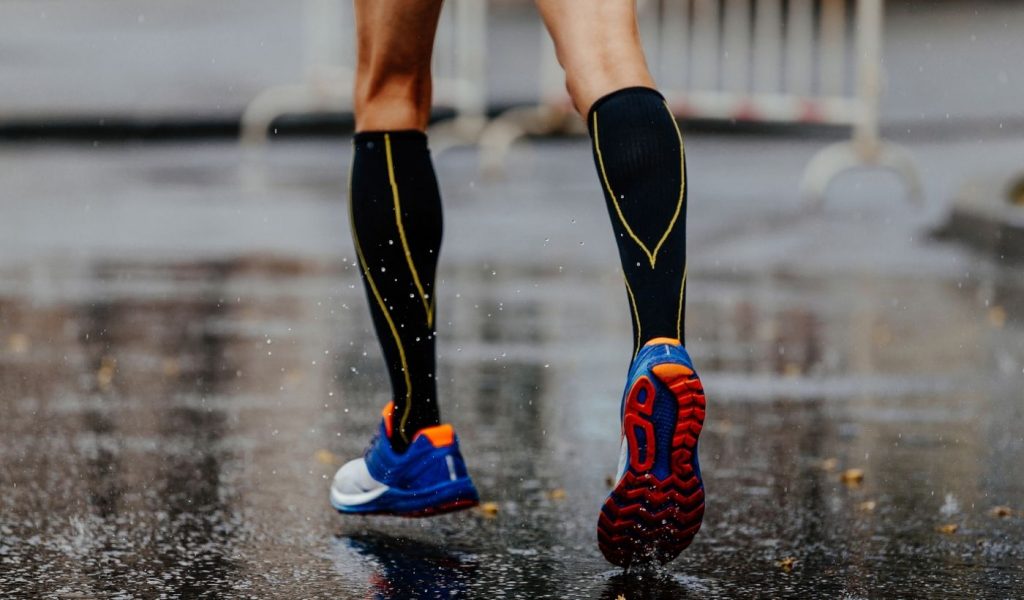 man wears compression socks in rain