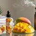 Glass tabletop still-life with a mango e-liquid bottle, sliced mango and tropical fruit, and subtle vapor in a wellness-themed vaping scene.